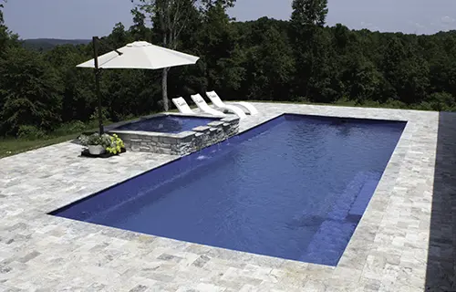 Leisure Pools The Grand rectangular fiberglass composite pool for lounging, installed by Leisure Pools Athens